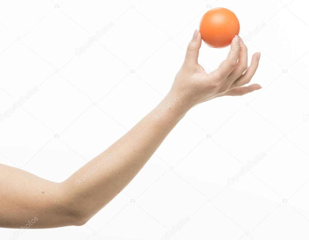 Female hand with orange sponge ball