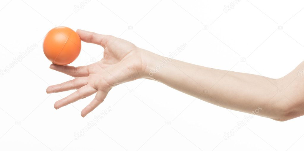 Female hand with orange sponge ball