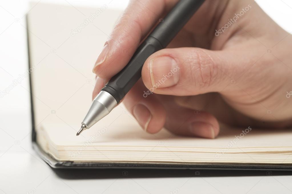 Female hand writing in notebook