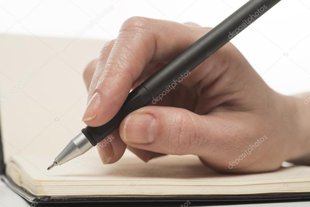 Female hand writing in notebook