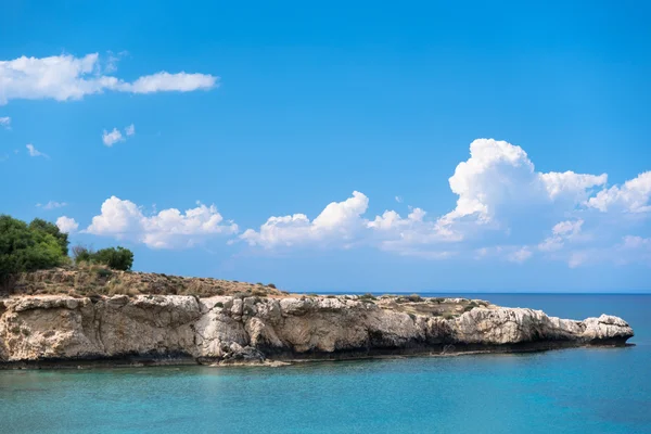 Rocky cape on at beautiful blue sea