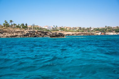 Distant rocky shore seen from a sea