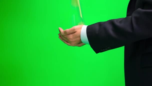 Man's outstretched hands catching gold coins on the greescreen. — Stock Video