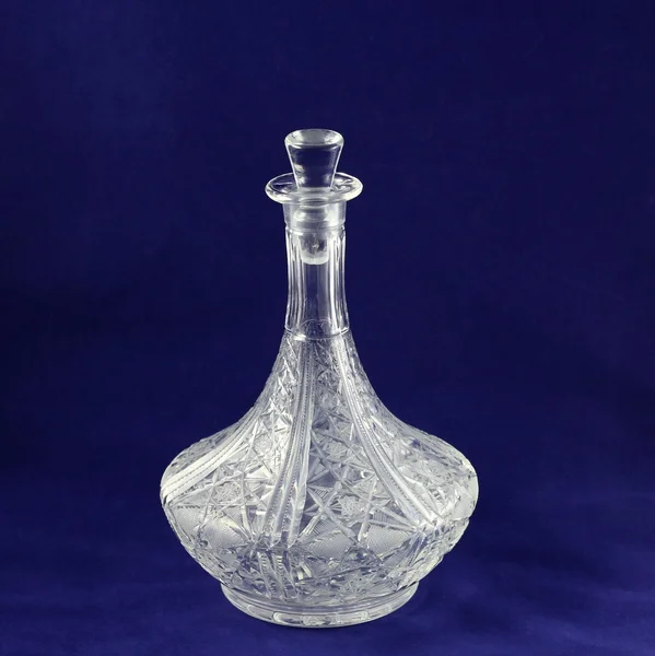 Decanter on blue background.