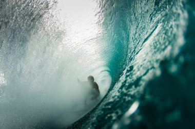 Surfer surfing in ocean wave clipart