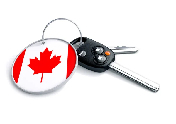 Set of car keys with keyring and country flag. Concept for car prices, buyer or selling a vehicle in Canada