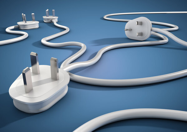 Electical cables and plugs lay on a blue smooth surface and overlap each other. Concept for electricity and power usage by consumers.