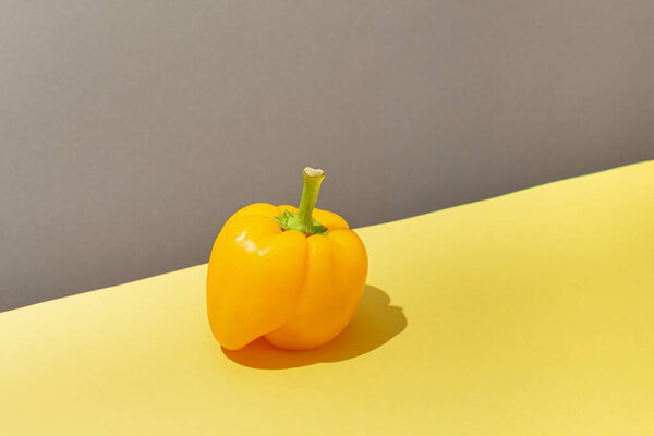 Fresh yellow pepper on a yellow background