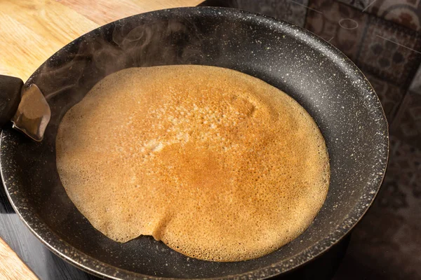 Frying cooking pancake on a frying pan. Home cooking