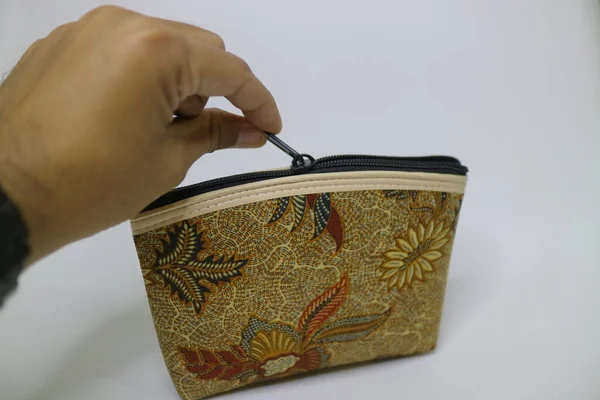 small brown pouch with batik motif photo