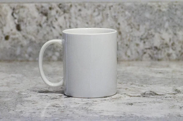White coffee cup sitting on granite counter