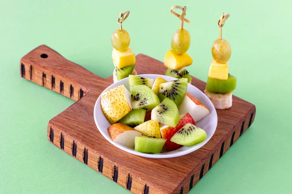 Vegan breakfast. variety of fruits on wooden cutting board, selective focus, fruit salad.