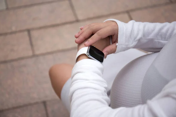 Asian Pregnant Woman using smart watch outdoor