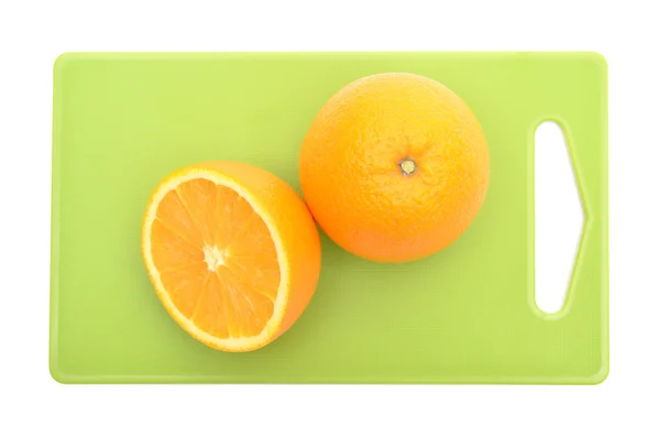 Oranges on green cutting board — Stock Photo, Image