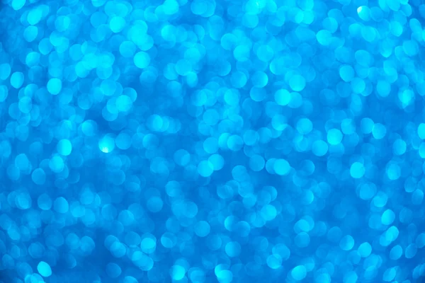 Bokeh ve parıltıların mavi arkaplanı