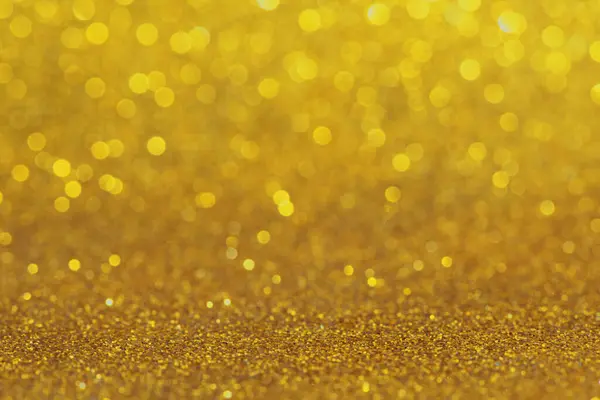 Bokeh ve parıltılardan oluşan altın bir arkaplan