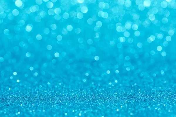 Bokeh ve parıltıların mavi arkaplanı