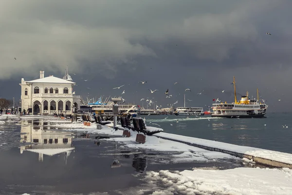 İstanbul, Türkiye - 17 Şubat 2021. Karlı bir kış gününde rıhtımdan kalkan şehir hatları feribotu.