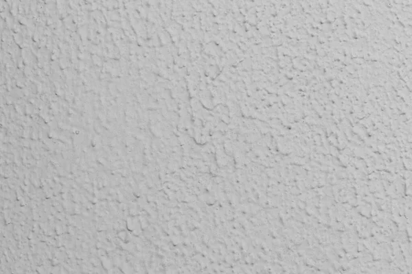 Duvarın griye boyanmış yakın çekimi.