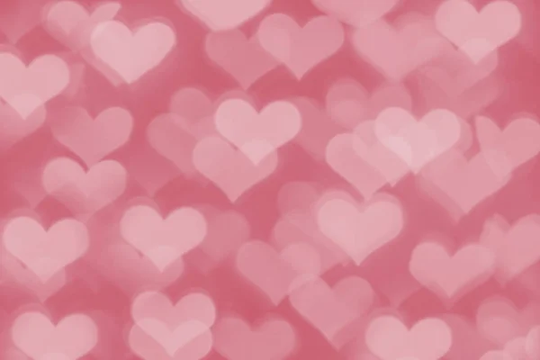 Kalp şeklinde bokeh ile pembe arkaplan.