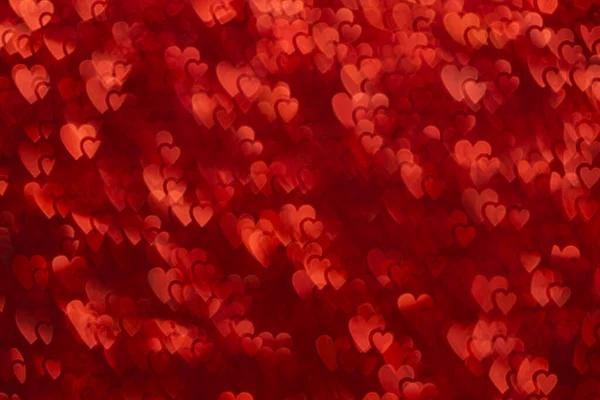 Kalp şeklinde bokeh ile kırmızı renkli arkaplan.