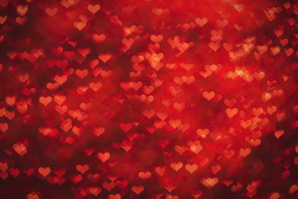 Kalp şeklinde bokeh ile kırmızı renkli arkaplan.