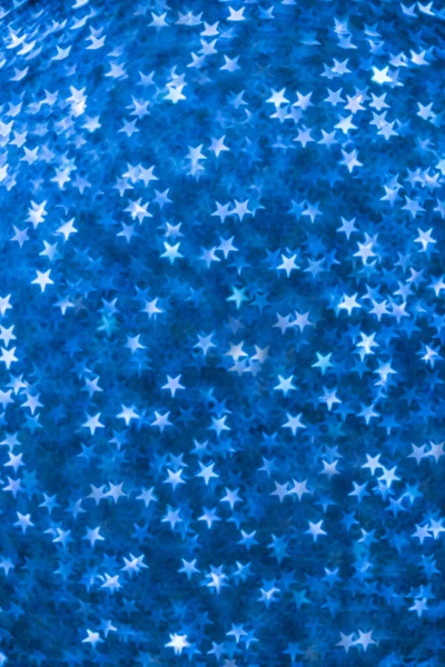 Yıldız şeklinde bokeh. Mavi arkaplan ile birleştirildiğinde.