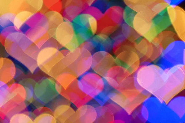 Renkli kalp şeklindeki bokeh 'in arka planı.