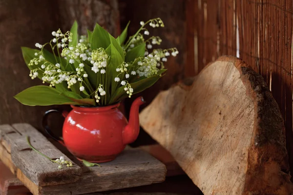 Bouquet of lily of the valley in the old red jug - vintage — Stock Photo, Image