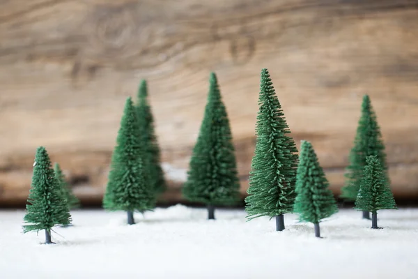 Christmas card - a miniature Christmas tree forest in the snow - winter — Stock Photo, Image
