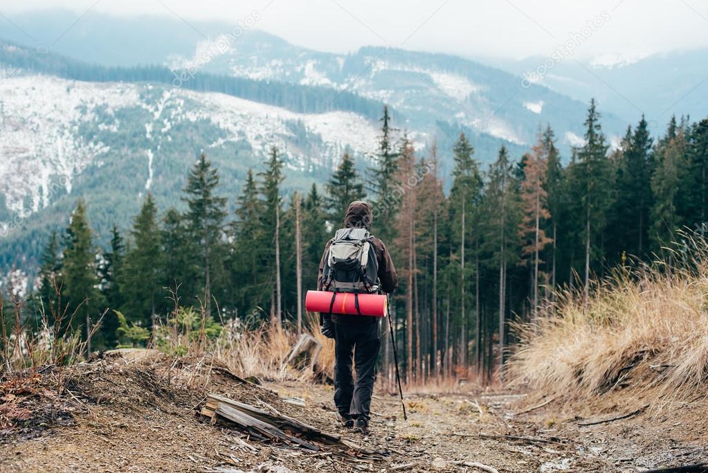 caucasian male hiking in mountains