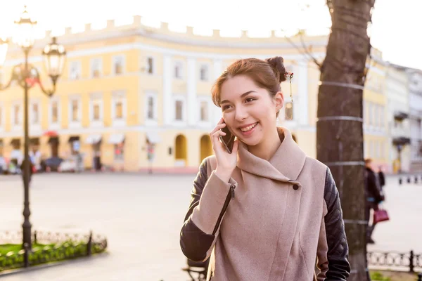 beautiful asian female speaking on phone on the street. Woman in