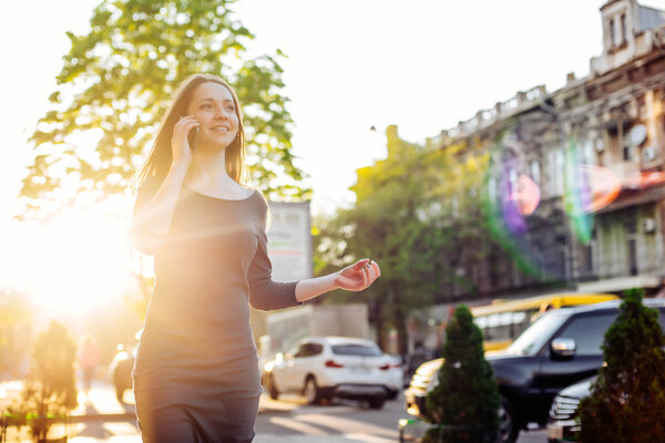  woman in city speaking on mobile phone