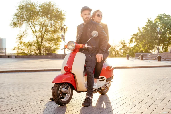 Jeune couple posant sur scooter — Photo