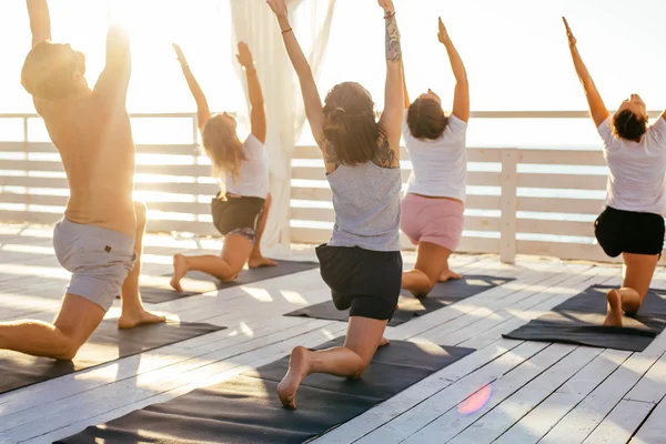 group of people practicing yoga