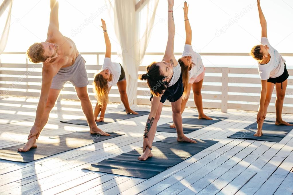 group of people practicing yoga 