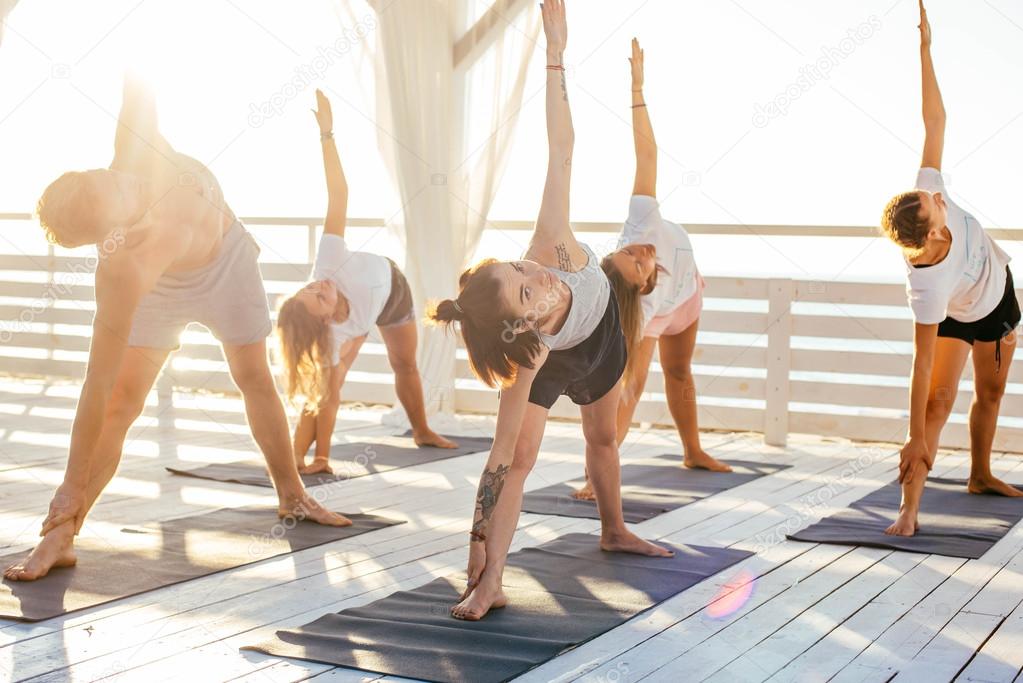 group of people practicing yoga 