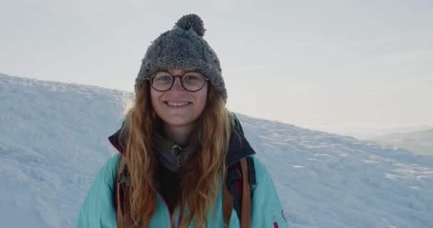 Portrait Young Smiling Red Haired Female Wearing Glasses Beanie Snowy — Stock Video