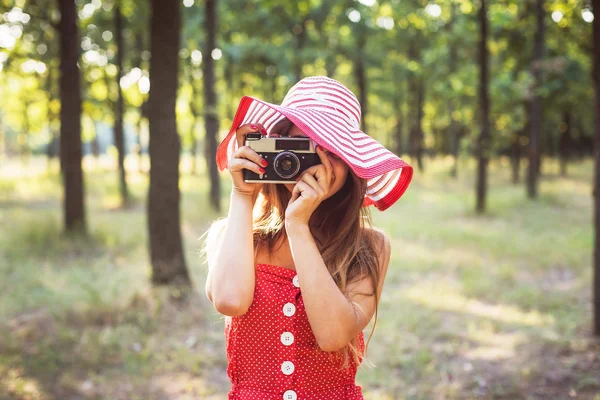 Giovane donna caucasica con fotocamera vintage nel parco — Foto Stock