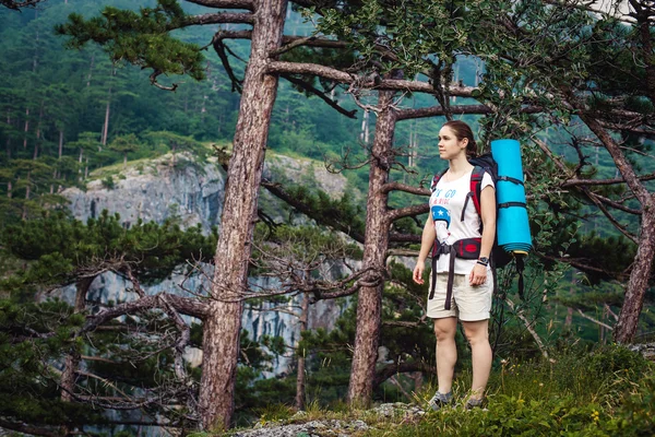 Caucasian hiker woman on trek in mountains with backpack living a healthy active lifestyle. Hiker girl on nature landscape hike in Crimea. — Stock Photo, Image