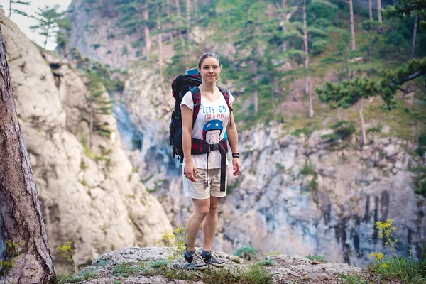 Caucasian hiker woman on trek in mountains with backpack living a healthy active lifestyle. Hiker girl on nature landscape hike in Crimea. — Stock Photo, Image
