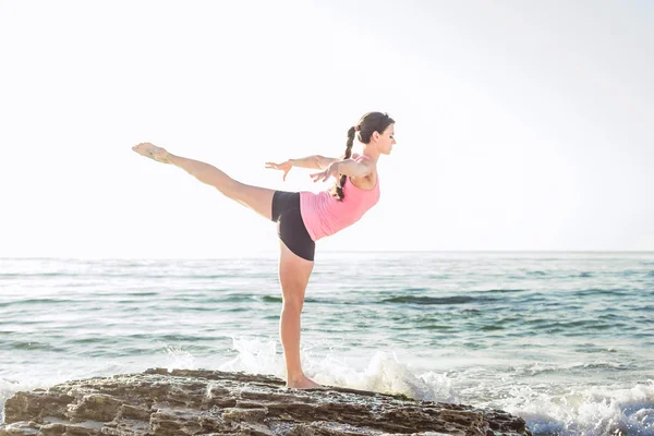 Mladý Kavkazský žena cvičení jógy u moře — Stock fotografie