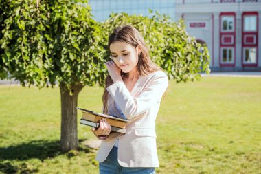kitap ve kampüste tablet ile genç beyaz kız öğrenci, öğrenci çalışma kampus alanının