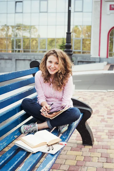 Jonge Kaukasische vrouwelijke student met boeken op de campus, student studie op het gebied van de campus — Stockfoto