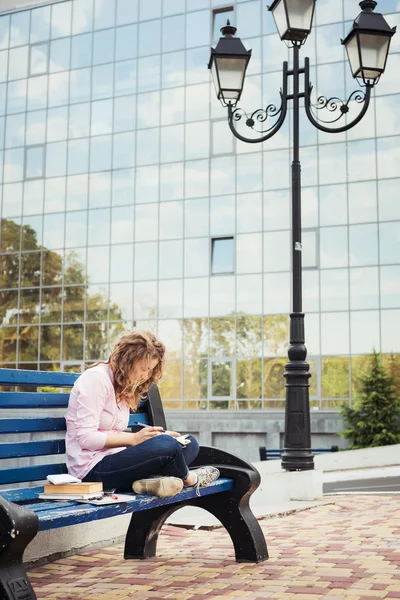 Young caucasian female student with books on campus, student study in campus area — Stock Photo, Image