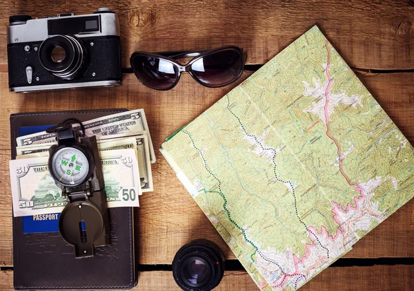 travel equipment -  map, vintage camera, sunglasses, compass, passport and money