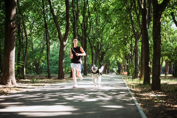 work out with dog. Young caucasian male running with siberian hu