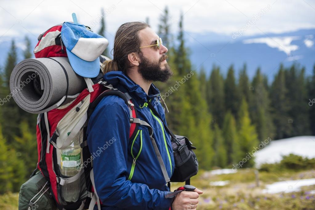 young caucasian male hiking in the mountains