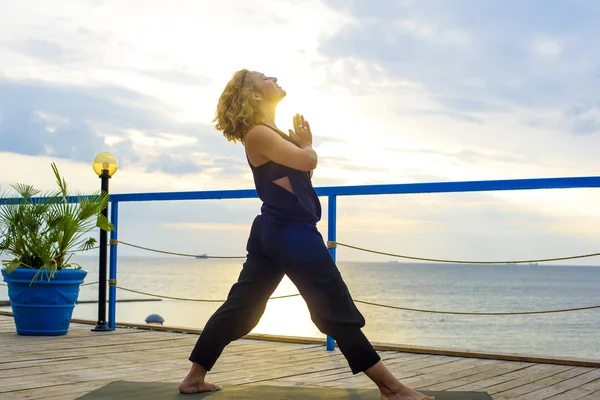 Girl practicing yoga on the seaside — Stock Photo, Image
