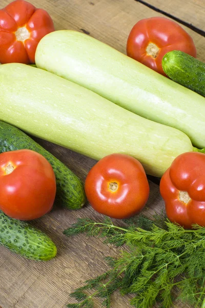 Fresh vegetables, squash, cucumbers, tomatoes and fennel on wooden background — Stock Photo, Image